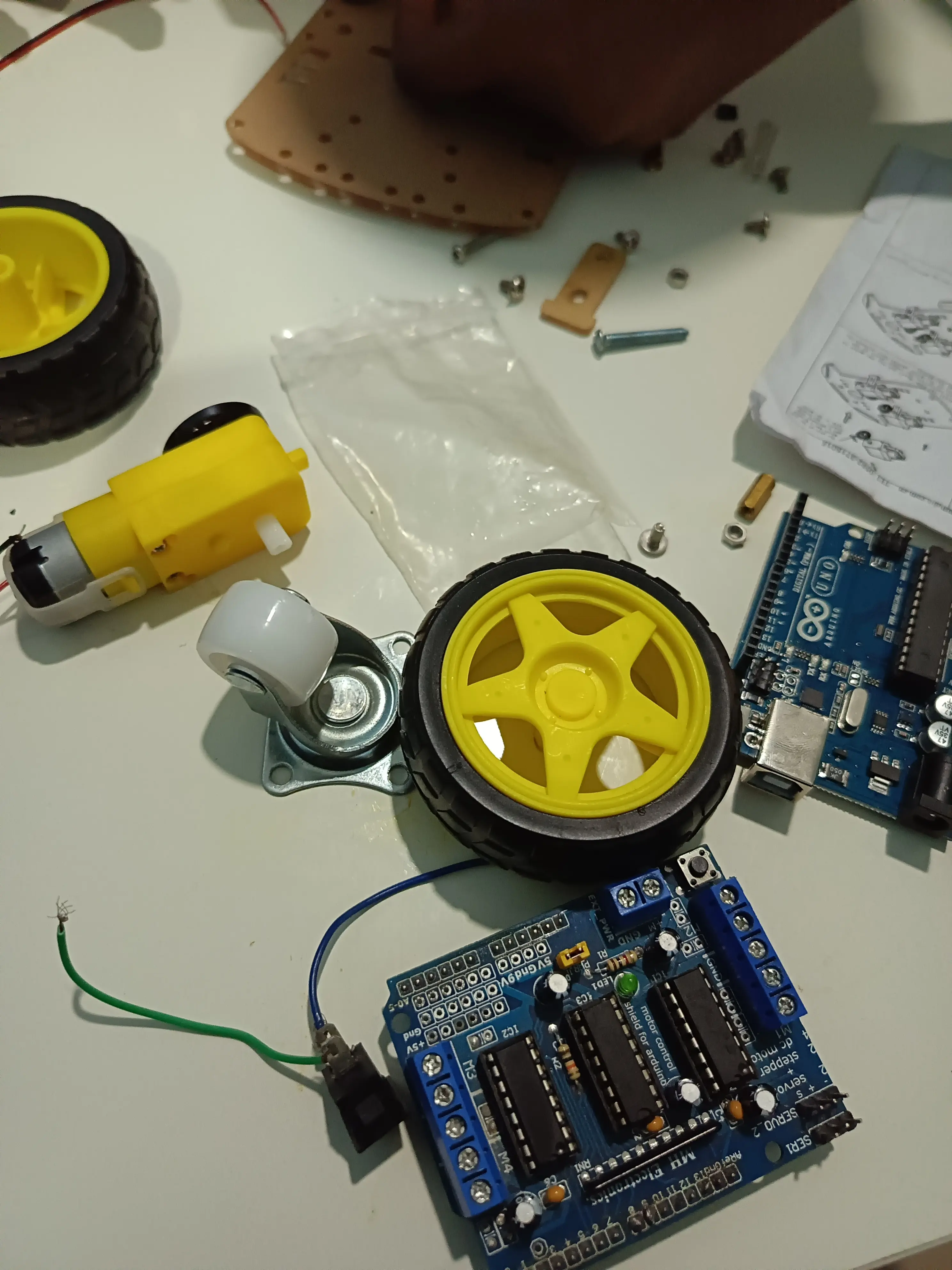 Teen David Amos with his first powered car, robot, and creative sketches